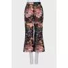 Black floral print trousers with tag