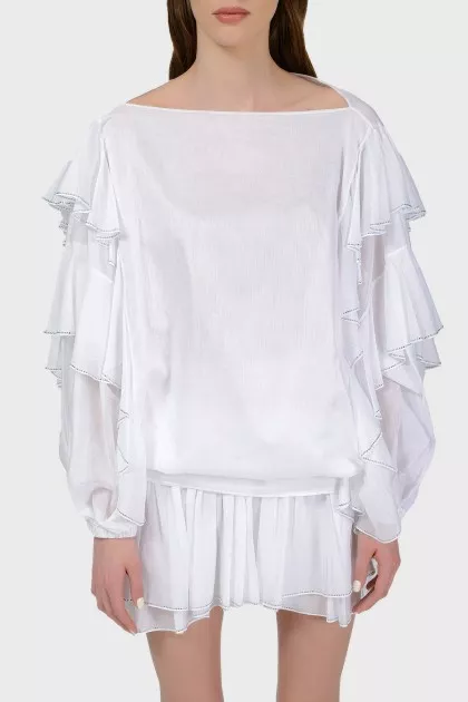 White blouse with stumps on the sleeves with a tag