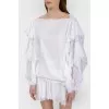 White blouse with stumps on the sleeves with a tag