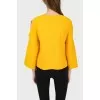 Knitted jumper with cuts on sleeves with a tag