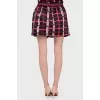 Mini skirt in an abstract cage with a tag