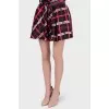 Mini skirt in an abstract cage with a tag