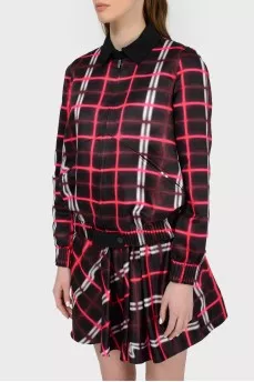 A jacket in an abstract checkered print with a tag