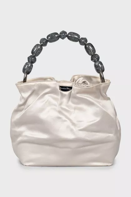 Bag with beaded handle