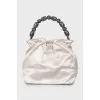 Bag with beaded handle