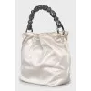 Bag with beaded handle
