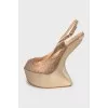 Leather sandals with gold wedge heel