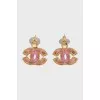 Earrings in the form of a company logo