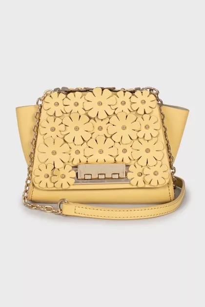 Leather bag decorated with flowers