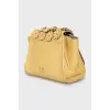 Leather bag decorated with flowers