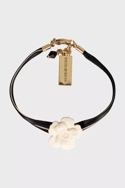 Textile bracelet decorated with a flower