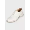 White leather shoes with a figured heel