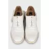 White leather shoes with a figured heel