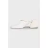 White mules with a figured heel