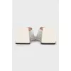 White mules with a figured heel