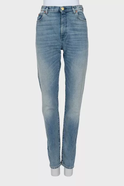Jeans decorated with embroidered patches