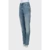 Jeans decorated with embroidered patches