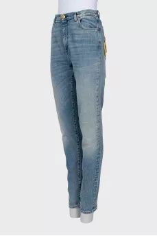 Jeans decorated with embroidered patches