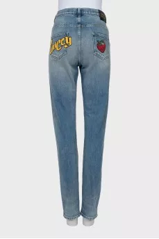 Jeans decorated with embroidered patches
