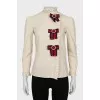 The shirt is decorated with bows