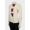 The shirt is decorated with bows