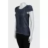 Blouse decorated with pleats