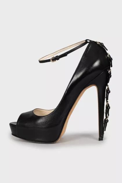 Leather shoes with buckles on the heel