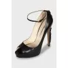 Leather shoes with buckles on the heel