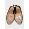 Leather shoes with buckles on the heel