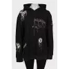 Black hoodie decorated with chains and rhinestones