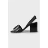 Leather sandals with a massive strap