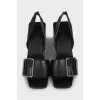 Leather sandals with a massive strap