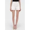 Mini shorts at a high waist with a tag
