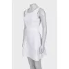 Fitted white dress with perforation