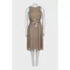 Pleated dress decorated with feathers