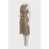 Pleated dress decorated with feathers