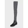 Black and white textile over the knee boots