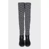Black and white textile over the knee boots
