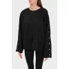 Black sweatshirt with buttons on the sleeves
