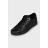Black sneakers with branded embossing