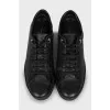 Black sneakers with branded embossing