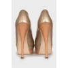 Gold patent leather shoes
