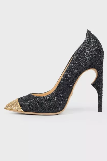 Shiny shoes with a golden toe with a tag