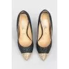 Shiny shoes with a golden toe with a tag