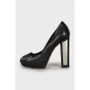 Leather shoes with decor on the heels