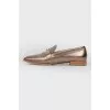 Gold colored loafers