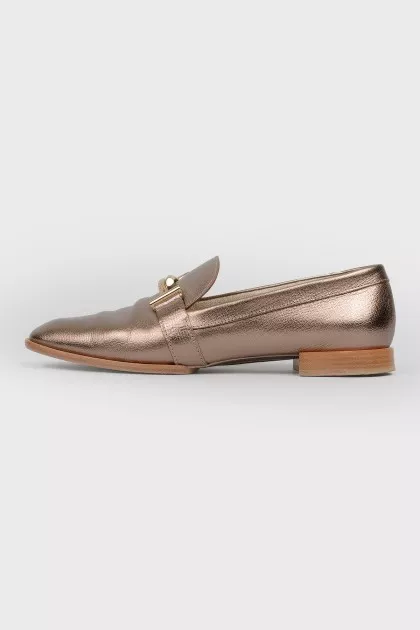 Gold colored loafers