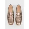 Gold colored loafers