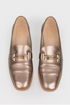 Gold colored loafers