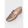 Gold colored loafers